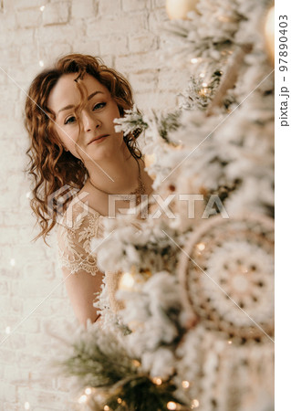 A young beautiful girl in a New Year's interior. A young beautiful girl in a New Year's interior. 97890403