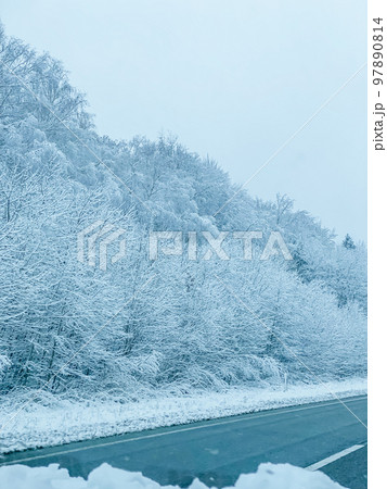 a view of the winter landscape from the window of the car a view of the winter landscape from the window of the car 97890814