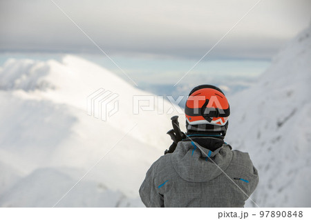 man skier enjoying landscape view of winter mountains man skier enjoying landscape view of winter mountains 97890848