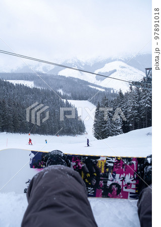 snowboarder point of view from the slope 97891018