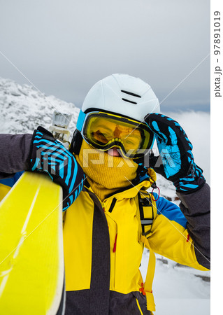 woman skier posing on the top of snowed mountain 97891019