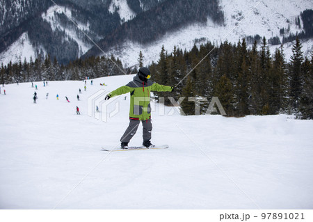 man snowboarder portrait on ski slope man snowboarder portrait on ski slope 97891021