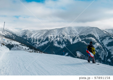 man snowboarder with slovakia flag at ski resort slope man snowboarder with slovakia flag at ski resort slope 97891158