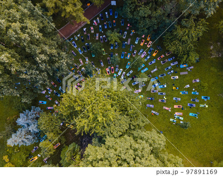 overhead view of people do yoga at city public park 97891169