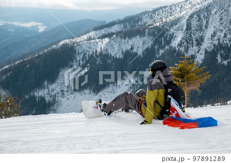 man snowboarder with slovakia flag at ski resort slope man snowboarder with slovakia flag at ski resort slope 97891289