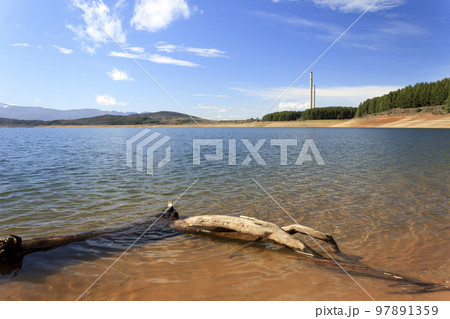 The Barcena reservoir with the chimneys of Compostilla thermal power station at background in Cubillos del Sil, el Bierzo, Castile and Leon, Spain. 97891359