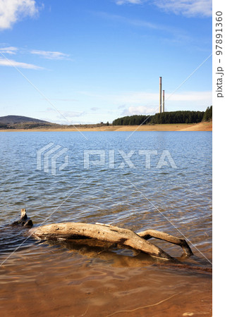The Barcena reservoir with the chimneys of Compostilla thermal power station at background in Cubillos del Sil, el Bierzo, Castile and Leon, Spain. 97891360