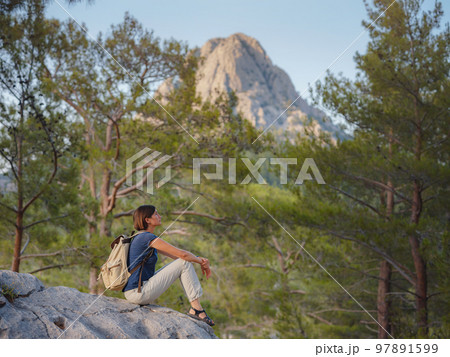 woman traveler walking by Lycian Way trail woman traveler walking by Lycian Way trail 97891599