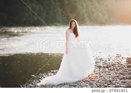 Beauty portrait of bride wearing fashion wedding dress with feathers with luxury delight make-up and hairstyle 97891851