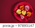 paper fortune cookies on red paper plate, korean or chinese style creative background, happy lunar new year 97893147