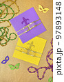 Multi color Mardi Gras background with beads and envelop. Top view 97893148