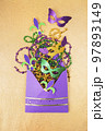 Multi color Mardi Gras background with beads and envelop. Top view 97893149