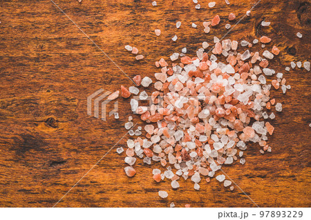 Pink himalayan salt on wooden table. Top view. 97893229