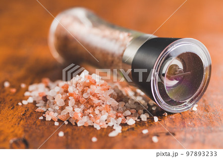 Pink himalayan salt on wooden table. 97893233