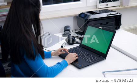Working with a laptop - green screen shot 97893522