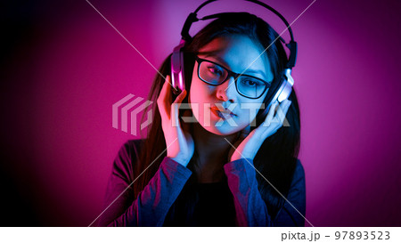 Young Asian woman dreams while listening to music 97893523