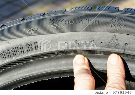 Markings on the sidewall of a new winter tire, speed, load, rotation, mud and snow designations 97893949