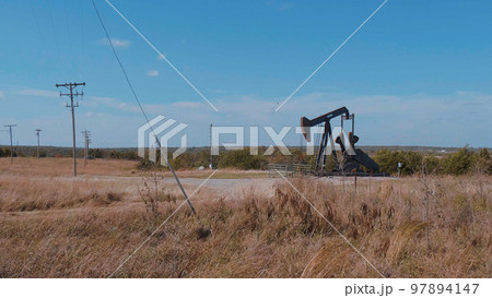 Oil pump in the countryside of Oklahoma - Pump jack 97894147