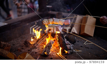 Toasting marshmallows over open fire - LONDON, UK - DECEMBER 20, 2022 Toasting marshmallows over open fire - LONDON, UK - DECEMBER 20, 2022 97894159
