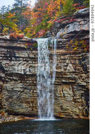 Detail of large waterfall over cliff edge into body of water Detail of large waterfall over cliff edge into body of water 97894942