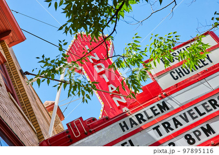 Detail of red Indiana sign through trees for theater in Bloomington Detail of red Indiana sign through trees for theater in Bloomington 97895116