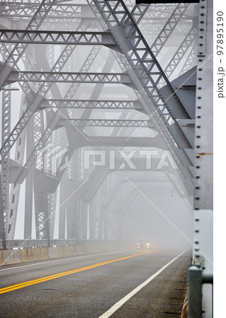 Cars going down extremely foggy steel bridge from side 97895190