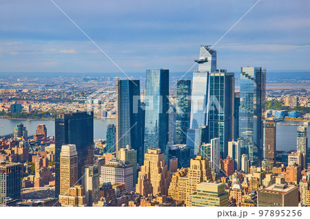 Cluster of huge blue glass skyscraper buildings in New York City from high up 97895256