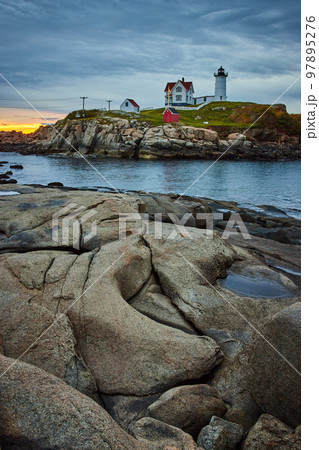Dawn light on coasts of Maine with Nubble Lighthouse on island 97895276