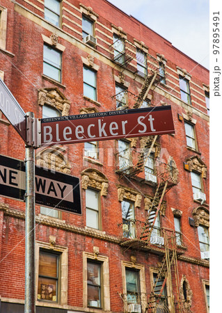 Bleecker Street sign in Greenwich Village New York City with brick building behind Bleecker Street sign in Greenwich Village New York City with brick building behind 97895491