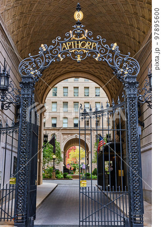 Black steel gates in New York City archway lead into beautiful private courtyard Black steel gates in New York City archway lead into beautiful private courtyard 97895600