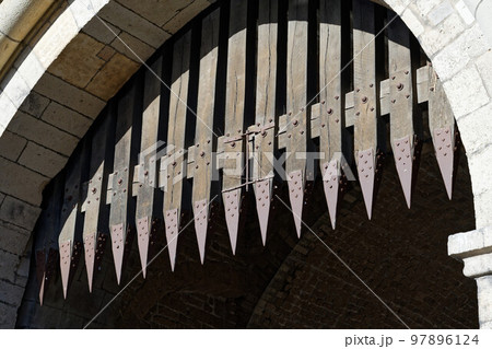 portcullis with metal spikes on a medieval gate 97896124