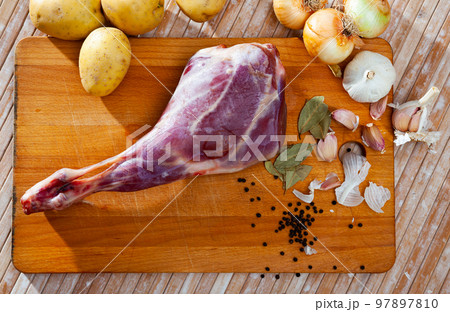 Raw lamb leg with natural ingredients before cooking 97897810