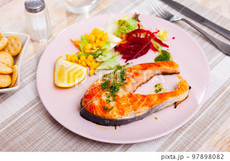 Salmon steak with beetroot, corn, lettuce salad Salmon steak with beetroot, corn, lettuce salad 97898082