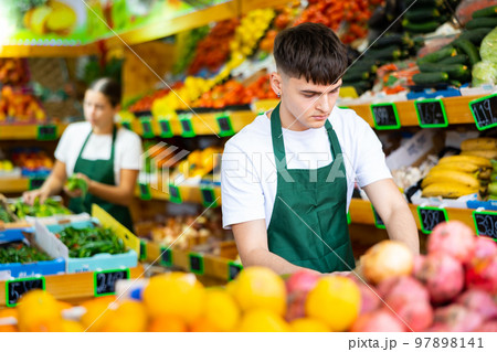 Portrait of a guy seller working in a vegetable store Portrait of a guy seller working in a vegetable store 97898141