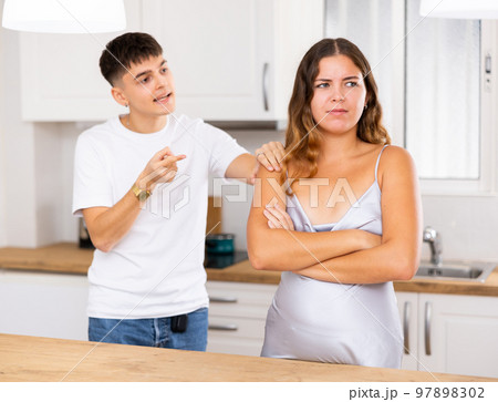Young husband makes claims to his wife in kitchen 97898302