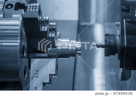 The multi-tasking CNC lathe machine  chamfer cutting the metal shaft parts by milling turret. 97899436