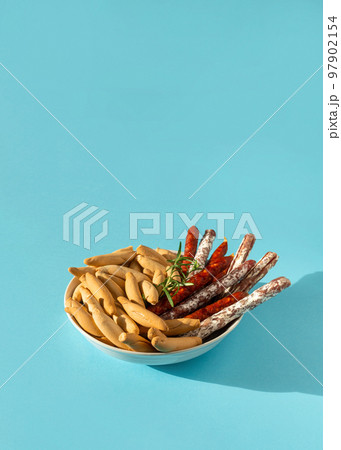 Spanish mini chorizo, fuet and picos on blue 97902154