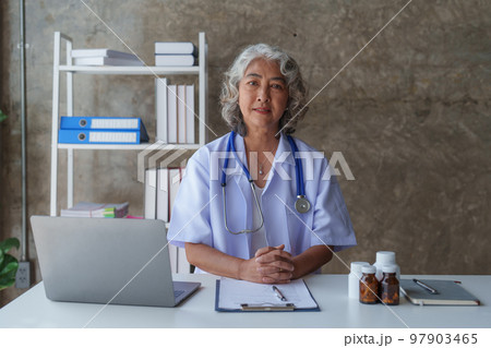 Doctor having conversation with patient while discussing explaining symptom and hold hand for encourage 97903465