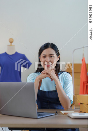 Asian Woman fashion designer cloth tailor creative working for new collection. Happy online store owner preparing an order for shipping Asian Woman fashion designer cloth tailor creative working for new collection. Happy online store owner preparing an order for shipping 97905995