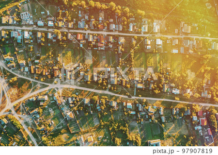 Daytime. Residential Houses. Small European City. Aerial View Of Town Village Cityscape Skyline In Summer Sunny Morning. Residential Areas Daytime. Residential Houses. Small European City. Aerial View Of Town Village Cityscape Skyline In Summer Sunny Morning. Residential Areas 97907819