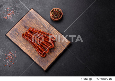 Delicious thin smoked meat sausages with spices and herbs Delicious thin smoked meat sausages with spices and herbs 97908530