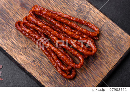 Delicious thin smoked meat sausages with spices and herbs 97908531