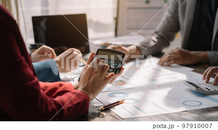 Close up Busines swoman and partner using calculator and laptop for calculation finance, tax, accounting, statistics and analytic research concept. Close up Busines swoman and partner using calculator and laptop for calculation finance, tax, accounting, statistics and analytic research concept. 97910007