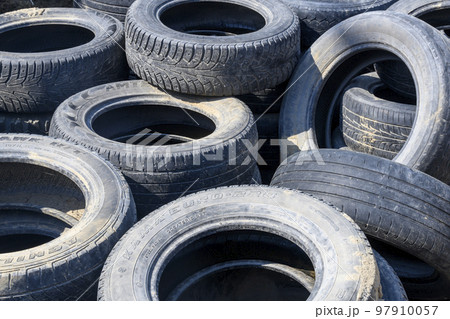 A bunch of old used worn out tires 97910057