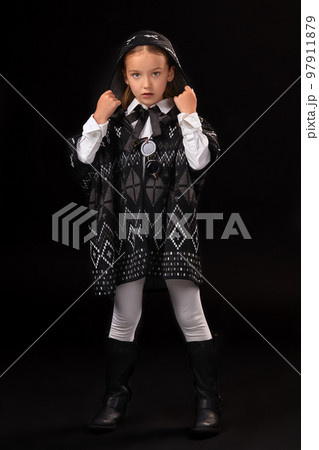Little girl in a hood and a dark poncho Little girl in a hood and a dark poncho 97911879
