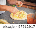 Baker man making a tasty pizza 97912917