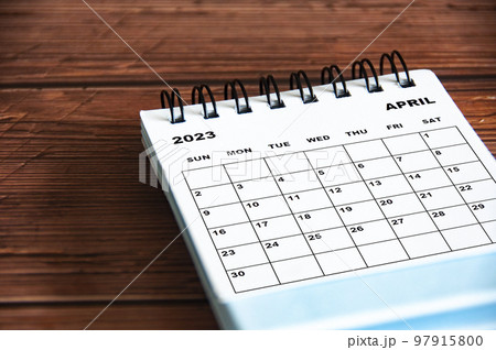 April 2023 white desk calendar on wooden table background. Calendar concept and copy space April 2023 white desk calendar on wooden table background. Calendar concept and copy space 97915800