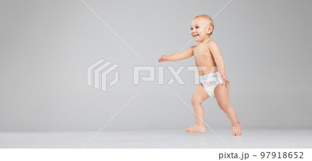 Full-length footage of cute toddler boy, baby in diaper isolated over grey studio background. Concept of happy childhood, motherhood, life, birth. 97918652