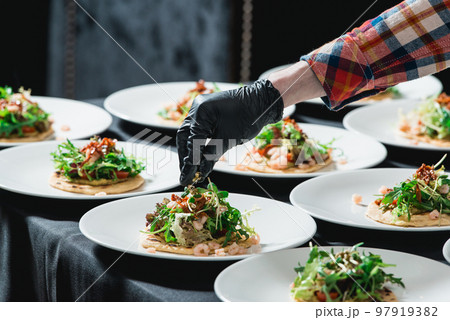 The chef at the restaurant making Spicy Shrimp Tacos with Coleslaw and Salsa The chef at the restaurant making Spicy Shrimp Tacos with Coleslaw and Salsa 97919382