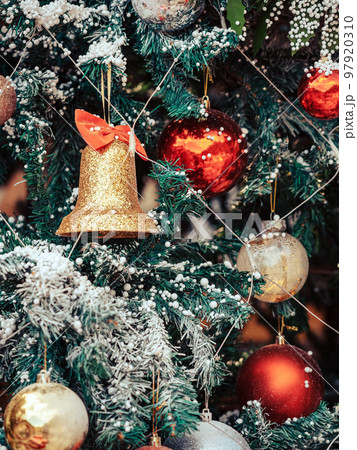 Golden jingle bells christmas ornament hanging on artificial pine tree. Stylish christmas decorations. Christmas and New Year display for celebration,carnival,festival design concept. Selective focus. Golden jingle bells christmas ornament hanging on artificial pine tree. Stylish christmas decorations. Christmas and New Year display for celebration,carnival,festival design concept. Selective focus. 97920310